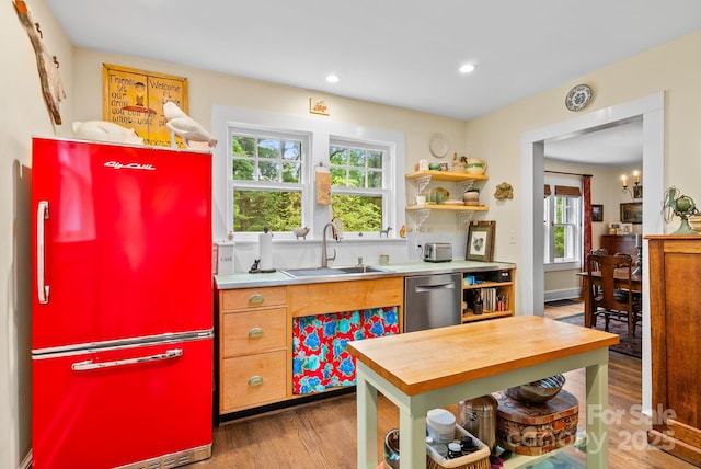 160 Hidden Hill Rd, Tryon, NC 28782 - kitchen with freestanding refrigerator, stainless steel dishwasher, a sink, wood finished floors, and healthy amount of natural light