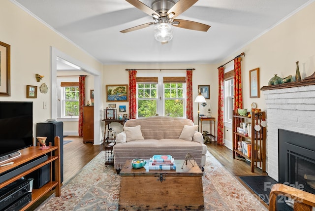 160 Hidden Hill Rd, Tryon, NC 28782 - living area featuring a brick fireplace, wood finished floors, ceiling fan, ornamental molding, and baseboards