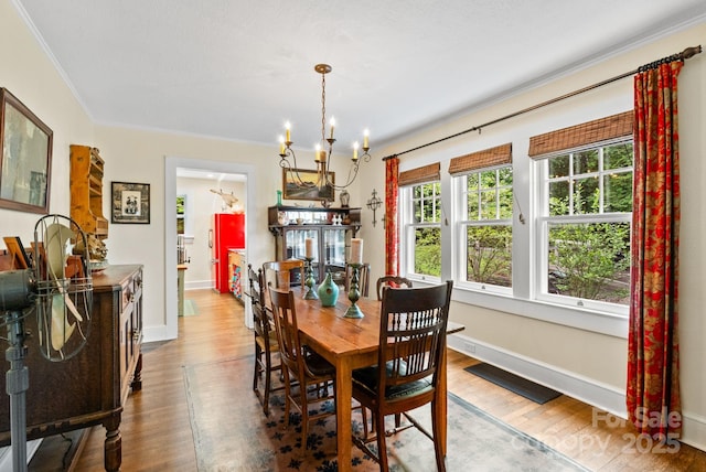 160 Hidden Hill Rd, Tryon, NC 28782 - dining room featuring wood finished floors, a chandelier, crown molding, and baseboards