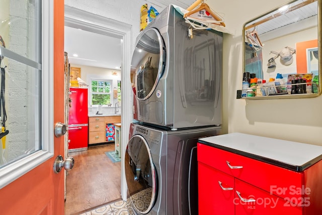 160 Hidden Hill Rd, Tryon, NC 28782 - washroom featuring estacked washer and dryer and wood finished floors