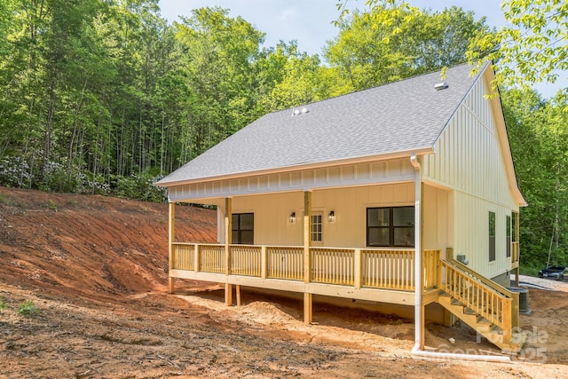 view of front of house featuring roof with shingles and central air condition unit