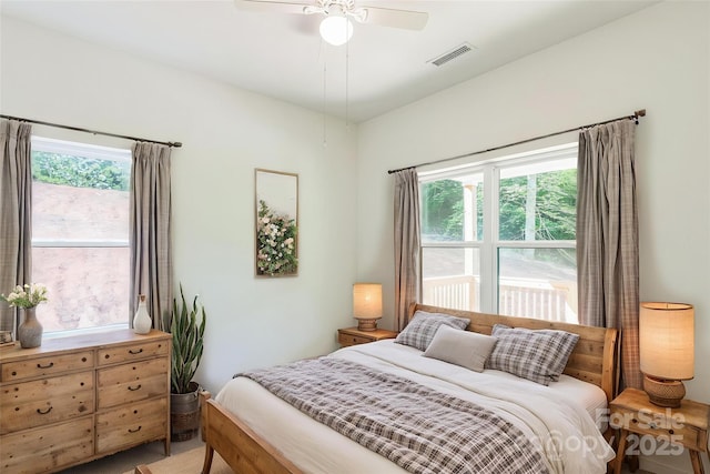 bedroom with multiple windows and a ceiling fan