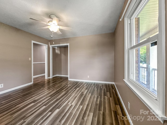 361 Settlemyer Rd, Morganton, NC 28655 - unfurnished bedroom featuring baseboards, a textured ceiling, a closet, dark wood-type flooring, and ceiling fan