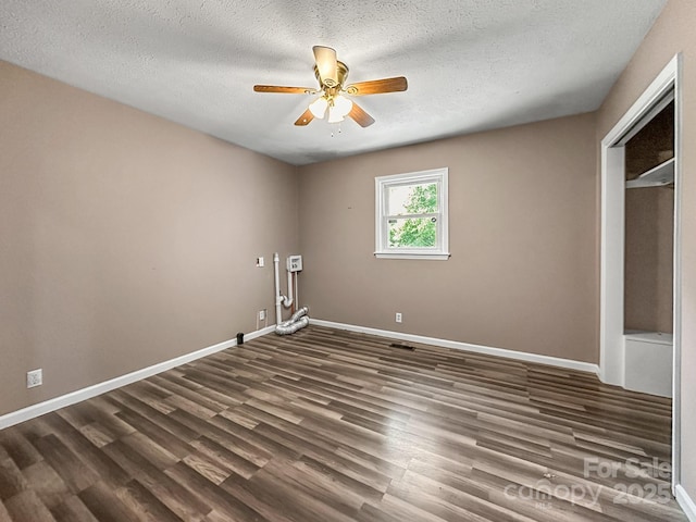 361 Settlemyer Rd, Morganton, NC 28655 - unfurnished bedroom with dark wood finished floors, a textured ceiling, baseboards, a ceiling fan, and a closet