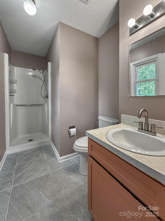 361 Settlemyer Rd, Morganton, NC 28655 - bathroom featuring toilet, baseboards, a shower, vanity, and a textured ceiling