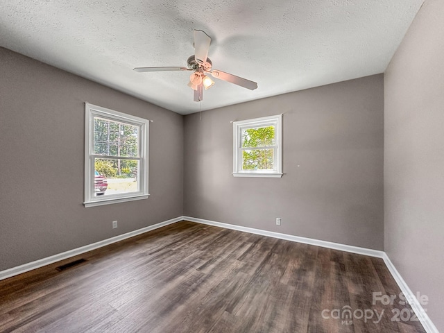 361 Settlemyer Rd, Morganton, NC 28655 - empty room featuring plenty of natural light, dark wood finished floors, ceiling fan, baseboards, and a textured ceiling