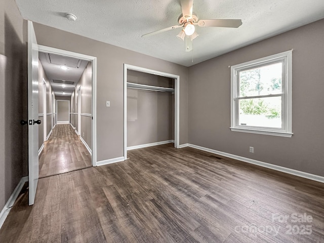 361 Settlemyer Rd, Morganton, NC 28655 - unfurnished bedroom with attic access, dark wood-type flooring, baseboards, a closet, and a textured ceiling