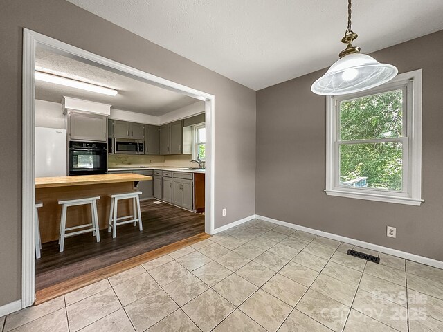 361 Settlemyer Rd, Morganton, NC 28655 - kitchen with oven, stainless steel microwave, plenty of natural light, and a sink