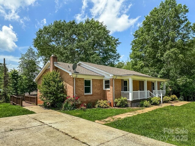 361 Settlemyer Rd, Morganton, NC 28655 - ranch-style house with a porch, brick siding, a front lawn, and a chimney