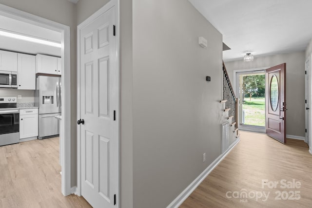 219 Proctor Dr, Salisbury, NC 28147 - foyer with light wood-style floors, stairway, and baseboards