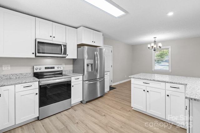 219 Proctor Dr, Salisbury, NC 28147 - kitchen with appliances with stainless steel finishes, a chandelier, and white cabinets