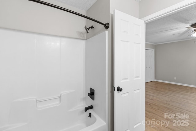 219 Proctor Dr, Salisbury, NC 28147 - bathroom featuring a textured ceiling, wood finished floors, shower / bathtub combination, ceiling fan, and baseboards