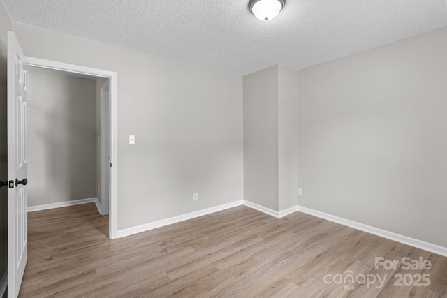 219 Proctor Dr, Salisbury, NC 28147 - empty room featuring wood finished floors, a textured ceiling, and baseboards