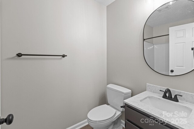 219 Proctor Dr, Salisbury, NC 28147 - bathroom featuring toilet, vanity, and a textured ceiling