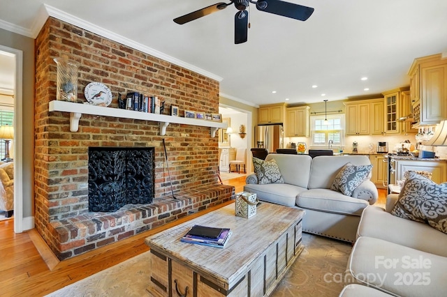 2025 Sagamore Rd, Charlotte, NC 28209 - living area featuring crown molding, light wood finished floors, a ceiling fan, a fireplace, and recessed lighting