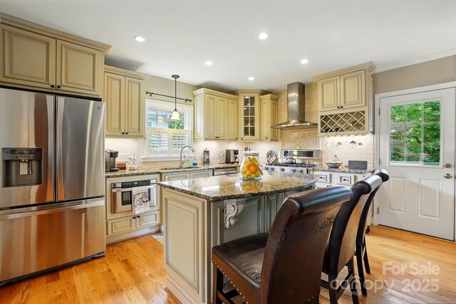2025 Sagamore Rd, Charlotte, NC 28209 - kitchen with cream cabinetry, stainless steel appliances, wall chimney range hood, a sink, and recessed lighting