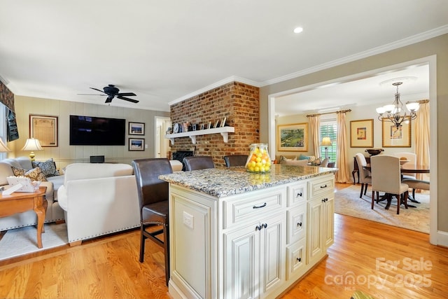 2025 Sagamore Rd, Charlotte, NC 28209 - kitchen featuring light wood finished floors, ornamental molding, a chandelier, a ceiling fan, and light stone countertops