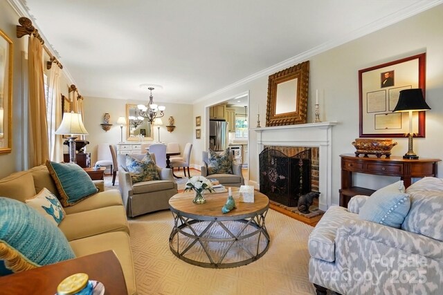 2025 Sagamore Rd, Charlotte, NC 28209 - living room featuring a chandelier, a brick fireplace, crown molding, and light wood-style floors