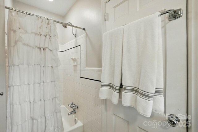 2025 Sagamore Rd, Charlotte, NC 28209 - bathroom featuring tile walls and shower / tub combo with curtain