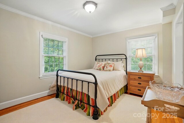 2025 Sagamore Rd, Charlotte, NC 28209 - bedroom with ornamental molding, wood finished floors, and baseboards