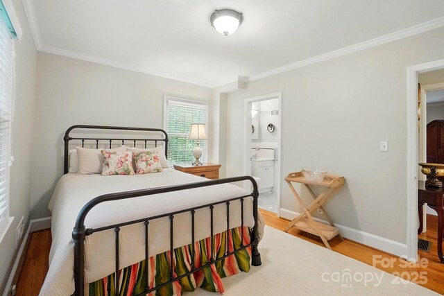 2025 Sagamore Rd, Charlotte, NC 28209 - bedroom with wood finished floors, ornamental molding, baseboards, and ensuite bath