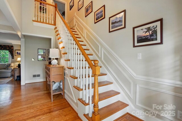 2025 Sagamore Rd, Charlotte, NC 28209 - staircase with a towering ceiling and wood finished floors