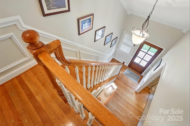 2025 Sagamore Rd, Charlotte, NC 28209 - stairway featuring crown molding, wood finished floors, and wainscoting