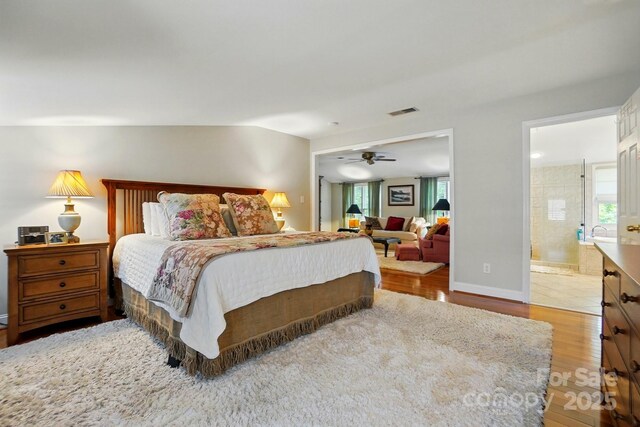 2025 Sagamore Rd, Charlotte, NC 28209 - bedroom with wood finished floors, connected bathroom, and baseboards