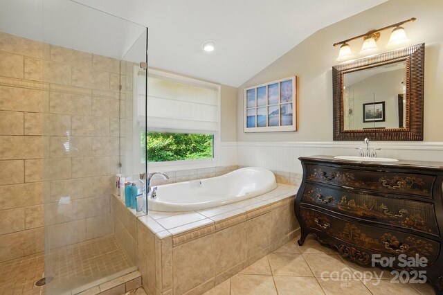 2025 Sagamore Rd, Charlotte, NC 28209 - full bathroom featuring vaulted ceiling, tile patterned floors, a bath, vanity, and a tile shower