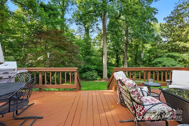 2025 Sagamore Rd, Charlotte, NC 28209 - wooden terrace with a grill, outdoor lounge area, and view of scattered trees