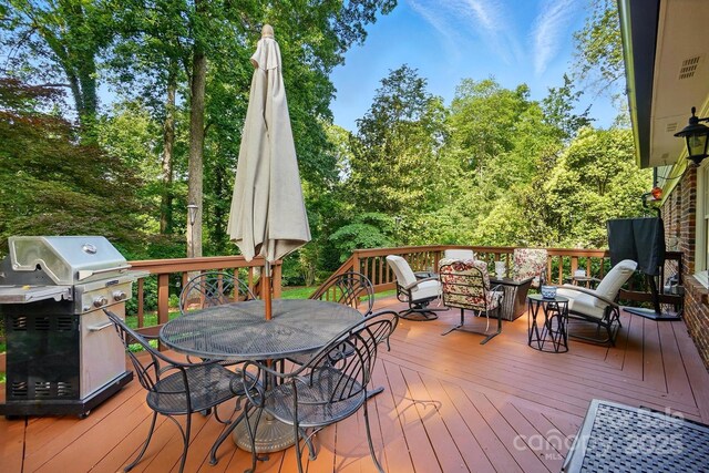 2025 Sagamore Rd, Charlotte, NC 28209 - wooden deck with outdoor dining area, area for grilling, and view of scattered trees