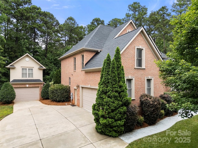 310 Ridge Reserve Dr, Clover, SC 29710 - view of home's exterior featuring roof with shingles, driveway, brick siding, and a garage