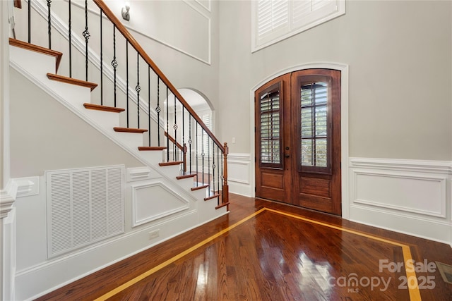 310 Ridge Reserve Dr, Clover, SC 29710 - foyer with hardwood / wood-style flooring, stairway, a decorative wall, arched walkways, and a wainscoted wall