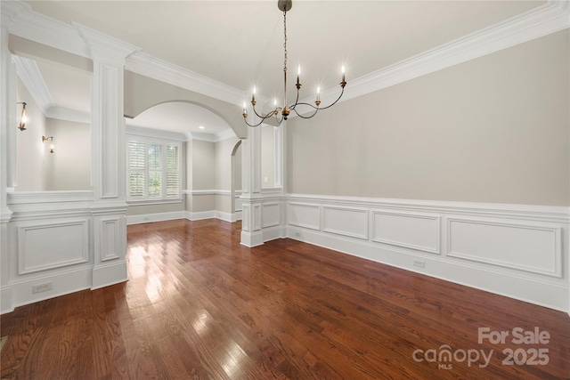 310 Ridge Reserve Dr, Clover, SC 29710 - unfurnished dining area featuring arched walkways, crown molding, dark wood-style flooring, a chandelier, and ornate columns