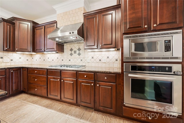 310 Ridge Reserve Dr, Clover, SC 29710 - kitchen featuring appliances with stainless steel finishes, wall chimney range hood, crown molding, light stone countertops, and decorative backsplash