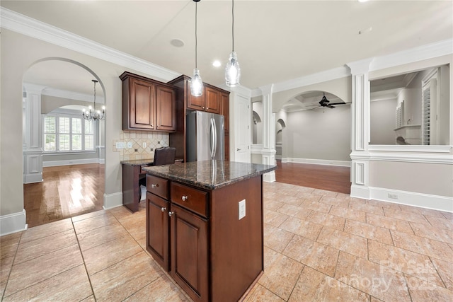 310 Ridge Reserve Dr, Clover, SC 29710 - kitchen with arched walkways, freestanding refrigerator, decorative columns, ceiling fan, and ornamental molding
