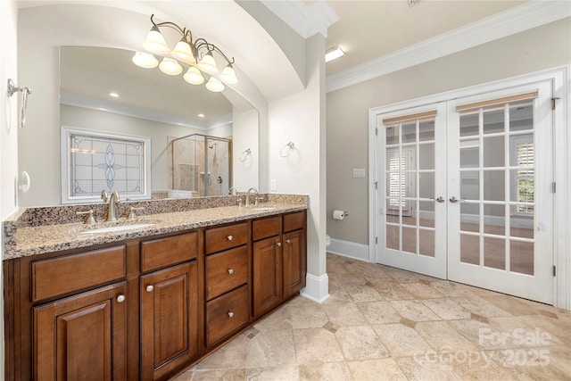 310 Ridge Reserve Dr, Clover, SC 29710 - full bath with french doors, crown molding, a shower stall, double vanity, and baseboards