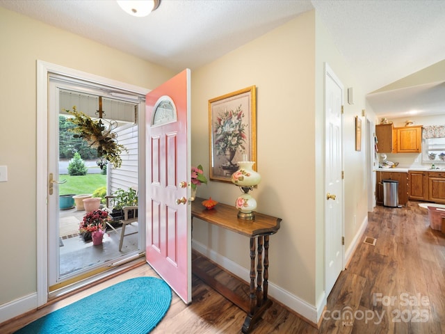 entryway featuring wood finished floors and baseboards