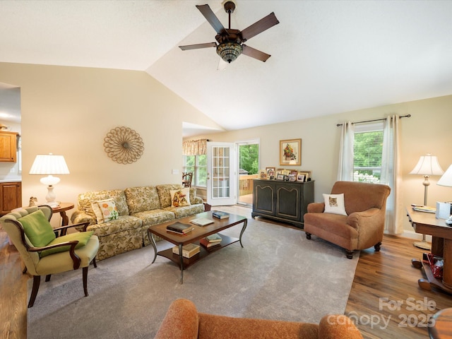 living room featuring ceiling fan, healthy amount of natural light, wood finished floors, and lofted ceiling