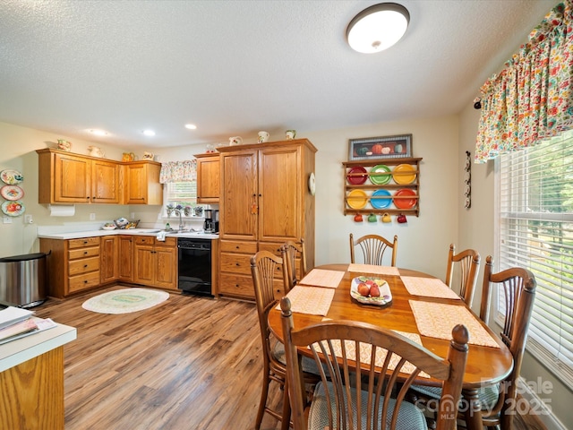 dining area with light wood finished floors and recessed lighting