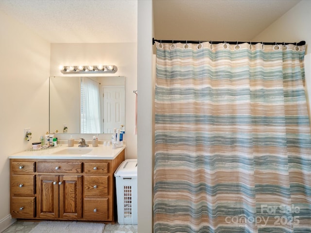 bathroom featuring vanity, a shower with curtain, and a textured ceiling