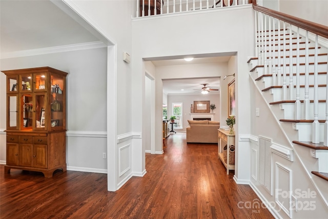 8612 Tintinhull Ln, Waxhaw, NC 28173 - foyer featuring stairs, wood finished floors, ceiling fan, crown molding, and a fireplace