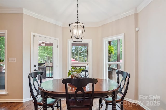8612 Tintinhull Ln, Waxhaw, NC 28173 - dining room with dark wood-type flooring, baseboards, crown molding, and a chandelier