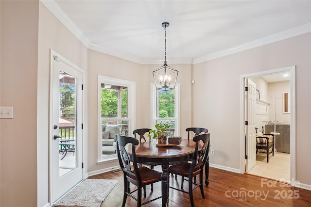 8612 Tintinhull Ln, Waxhaw, NC 28173 - dining space featuring dark wood-style flooring, a chandelier, crown molding, and baseboards