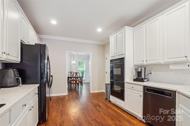 8612 Tintinhull Ln, Waxhaw, NC 28173 - kitchen featuring black appliances, white cabinets, crown molding, dark wood-type flooring, and light stone counters