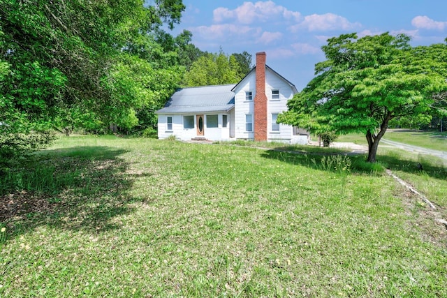 5604 NC-152 Hwy E, Rockwell, NC 28138 - view of front of property with a chimney, a front lawn, and metal roof