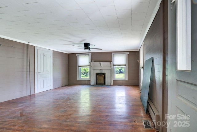 5604 NC-152 Hwy E, Rockwell, NC 28138 - unfurnished living room featuring a ceiling fan, wood finished floors, ornamental molding, and a fireplace
