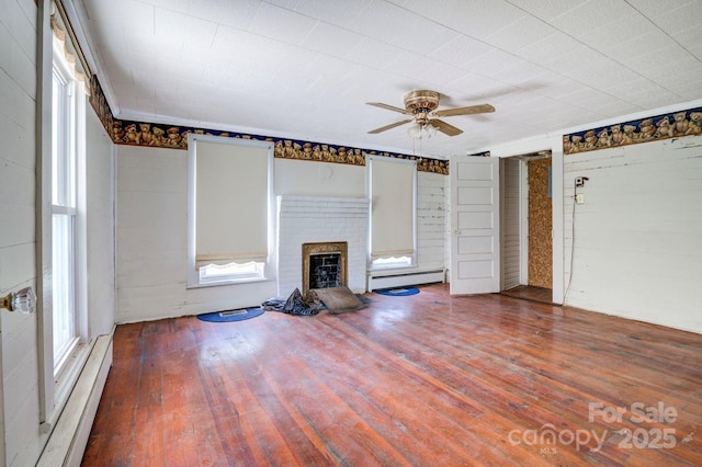 5604 NC-152 Hwy E, Rockwell, NC 28138 - unfurnished living room featuring baseboard heating, hardwood / wood-style floors, a fireplace, and ceiling fan