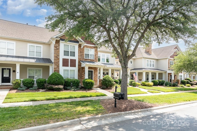2324 Bonterra Blvd, Indian Trail, NC 28079 - view of property featuring a standing seam roof, a front yard, a residential view, and covered porch