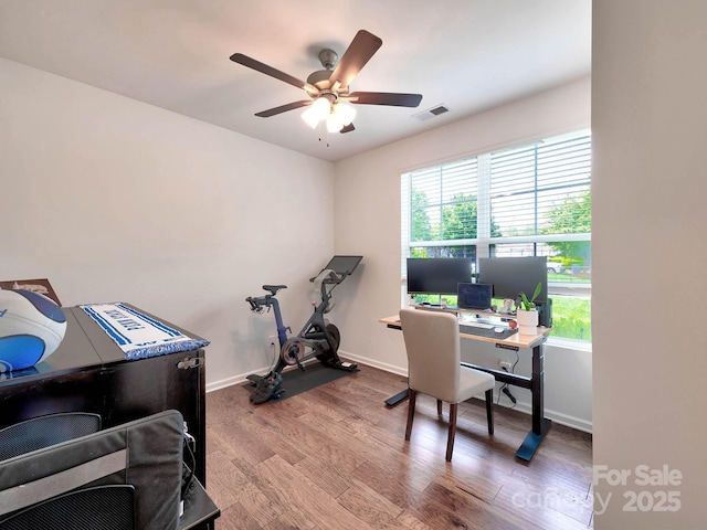 home office featuring wood finished floors, a ceiling fan, and baseboards